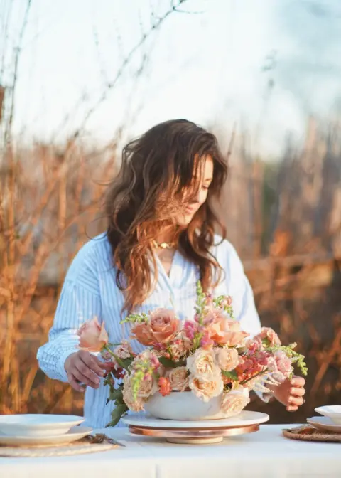 Busy Bee Bouqets owner Madi Blasingame posing with a bouquet